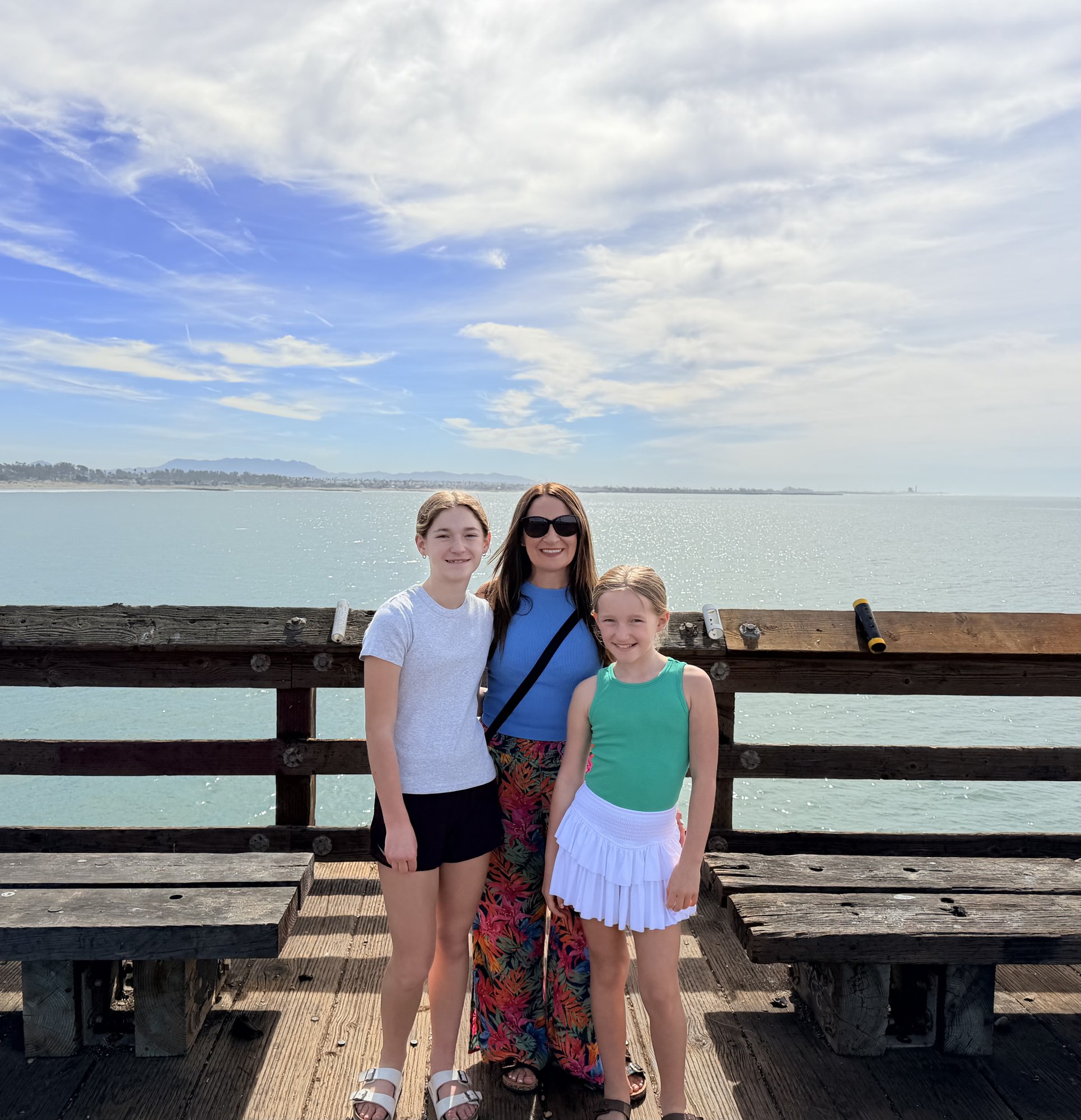 Tara Allen with her daughters on an ocean pier